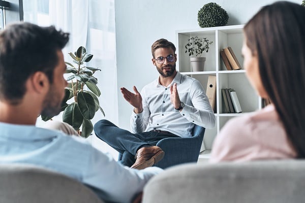 helping couples. young married couple listening to psychologist while sitting on the therapy session