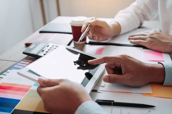 two businessmen are working analyzing the company annual budget