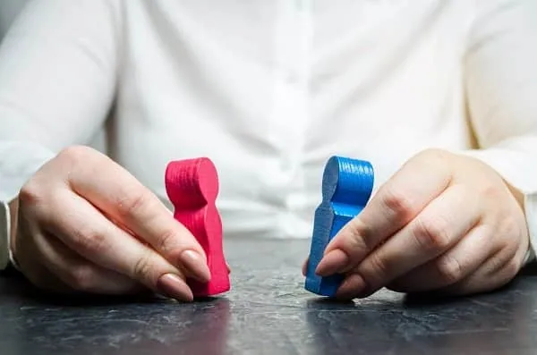 Woman Holds Wooden Figures Of A Man And A Woman 2021 08 31 06 47 13 Utc