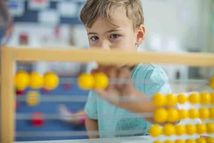 boy in kindergarten using abacus