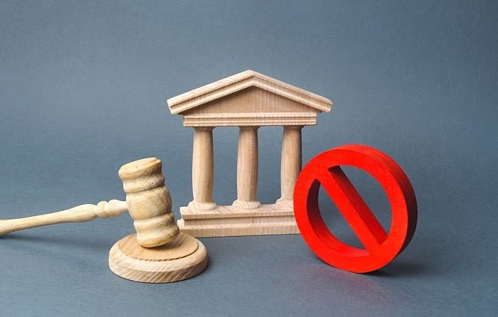 courthouse with judge's gavel and sign no. concept of censorship and the production of restrictions and laws on restriction. anti popular laws, usurpation of power, conservative views. lack of justice