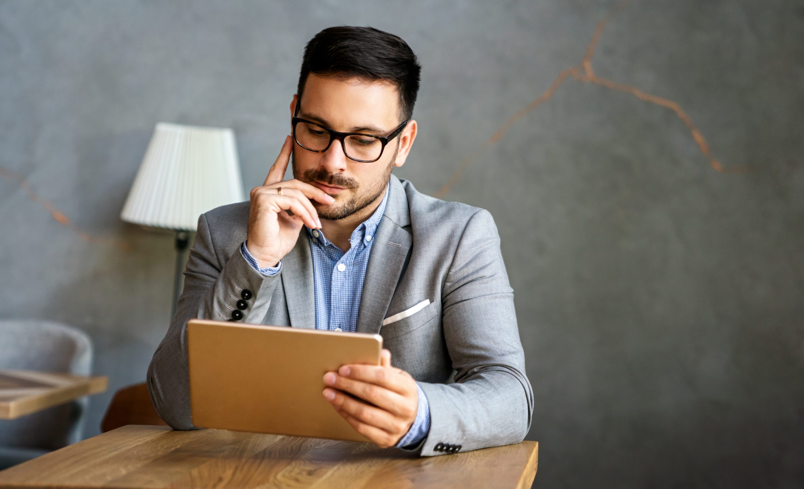 portrait of young business man working on digital tablet