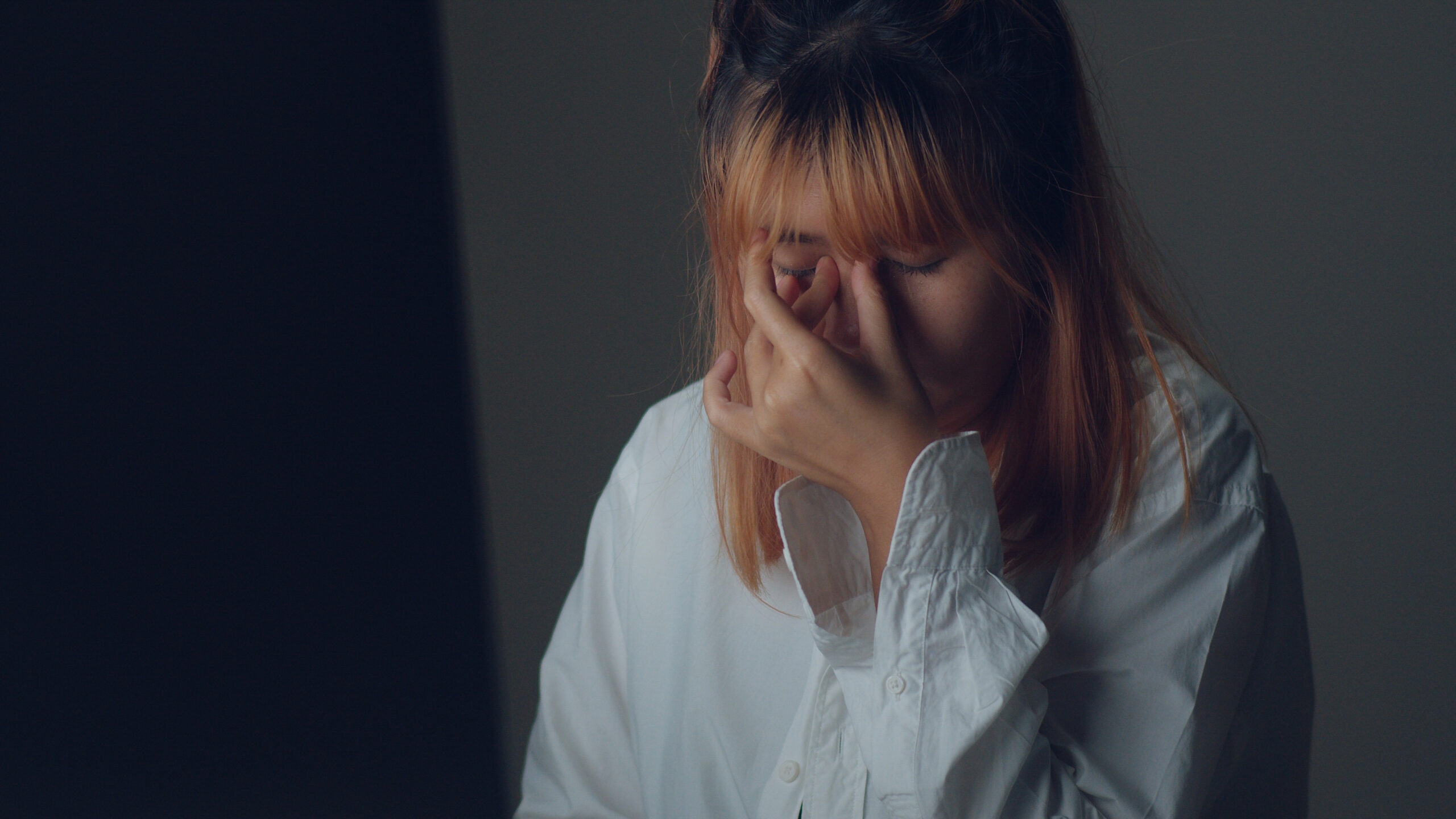 young asian woman working late using laptop on desk in living ro